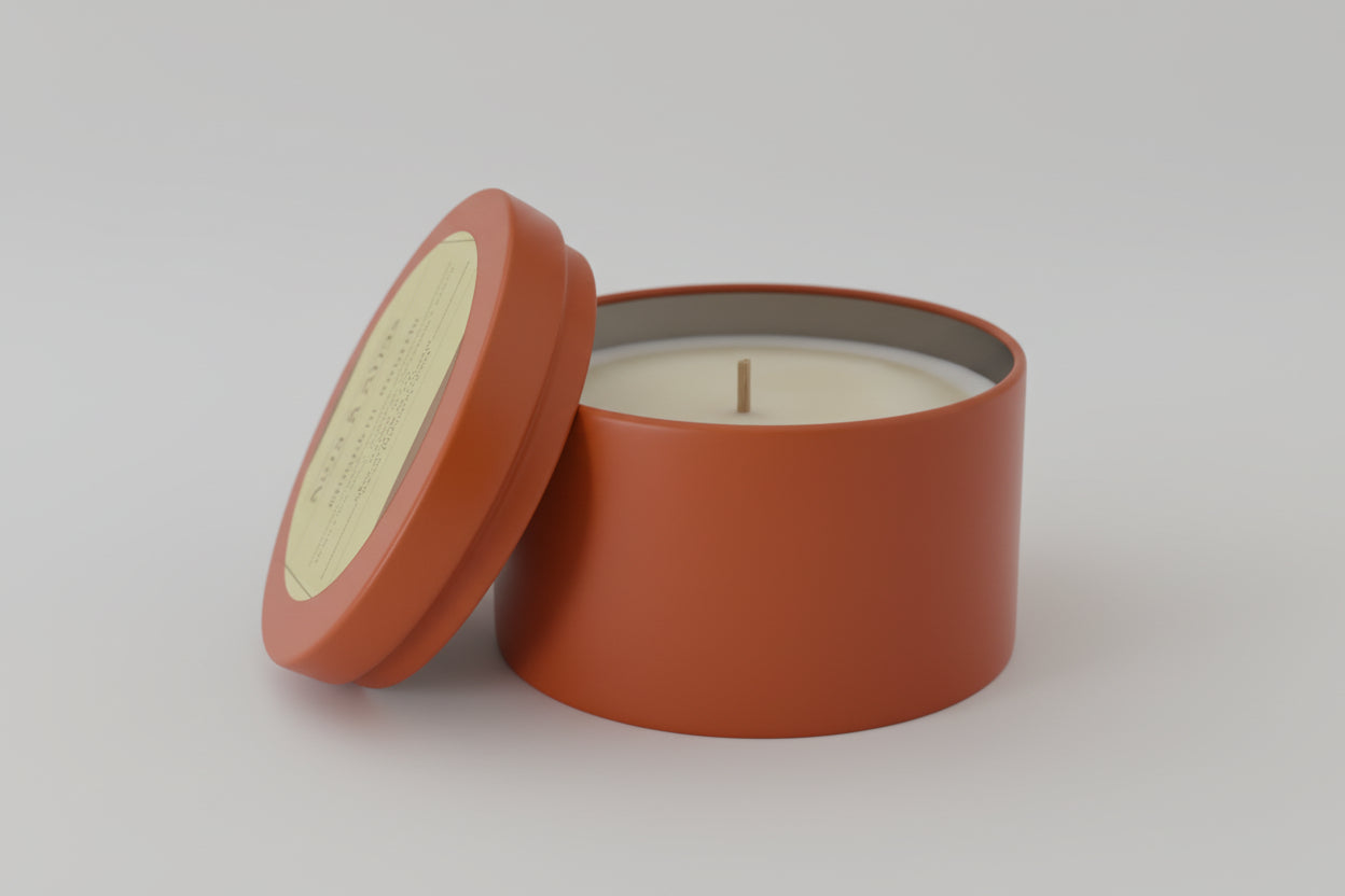 Candle in a terracotta container on a light gray background