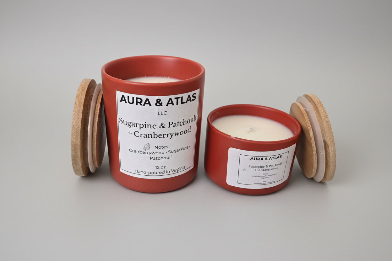 Two red candles with labels on a white surface