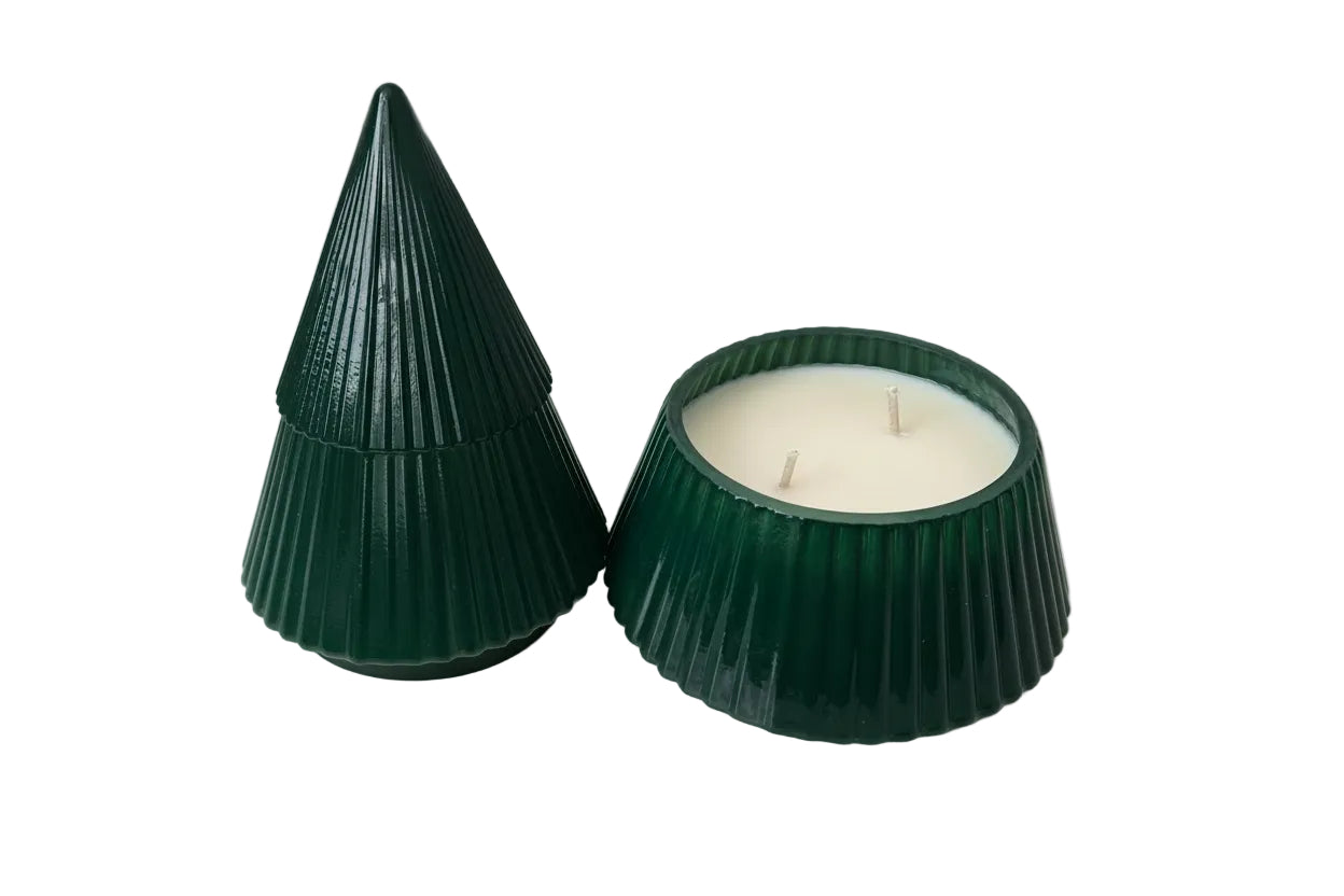 Two green candle holders with candles inside on a white surface.