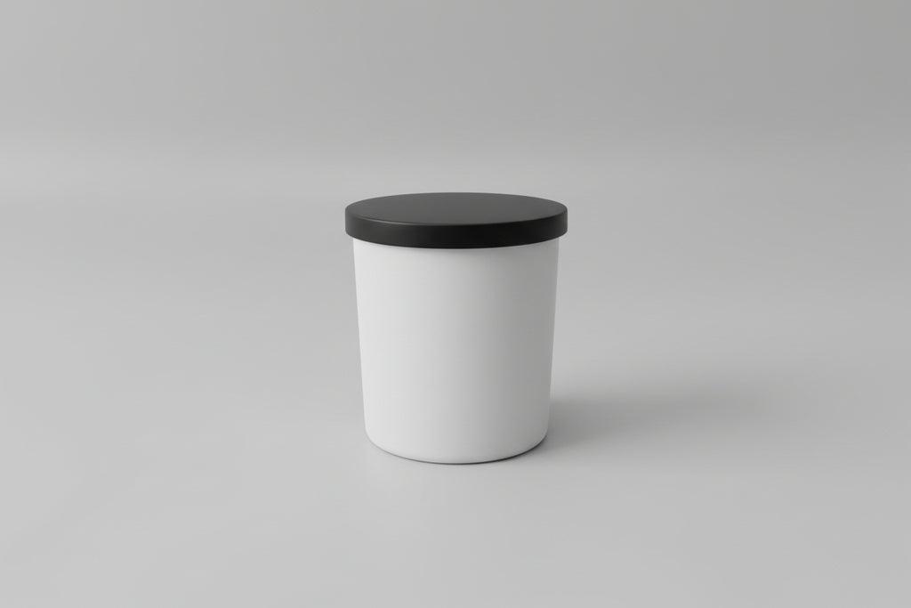 White container with a black lid on a light gray surface
