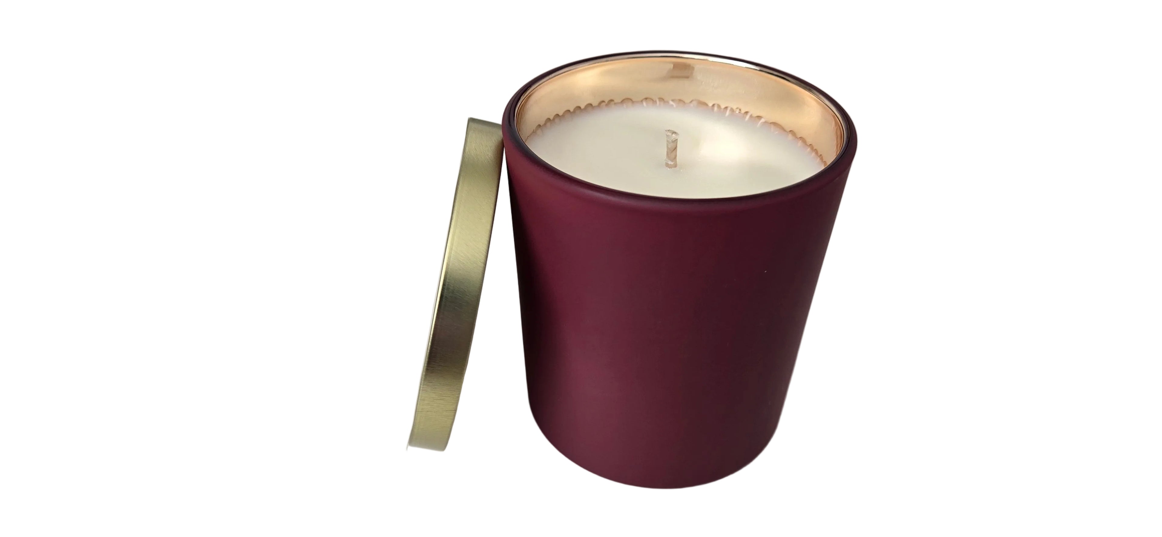 Maroon candle holder with a gold lid on a white surface
