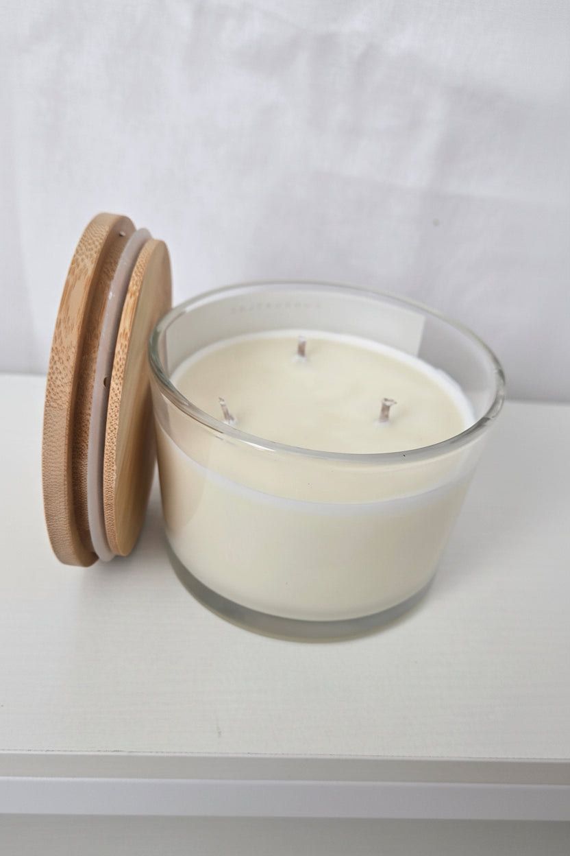 Wall-mounted clock with wooden base on a light gray wall