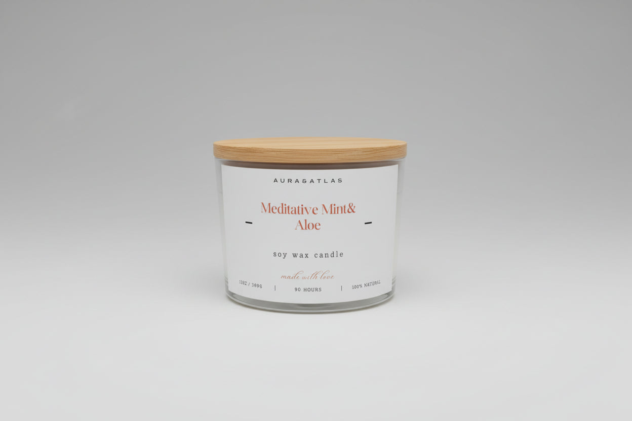 White candle with wooden lid on a white surface