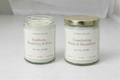 Two candles labeled 'Jasmine Tea & Bamboo' by Aura & Atlas on a white background.
